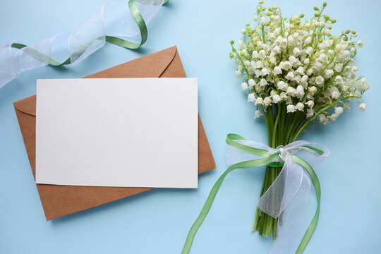 postcard mackup. small spring bouquet of lilies of the valley and space for text 