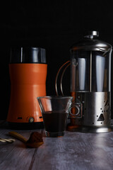 Grinder, coffee pot, cup, wooden cucahara and coffee