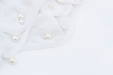 White wavy fabric with pearls . Wedding background
