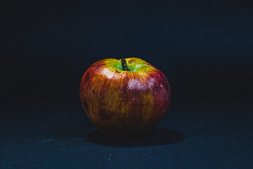 Multicolored rotten spoiled ripened apples on white background