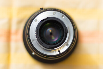 Photo of a lens for a camera. The background is blurred. Shallow depth of field