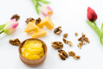 Honey and cheeses on white background