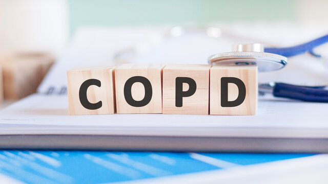 Wooden block form the word Copd with stethoscope on the doctor's desktop. Medical concept.