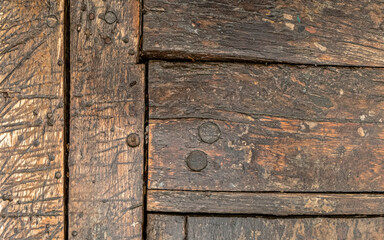 weathered natural wooden structure closeup, brown background