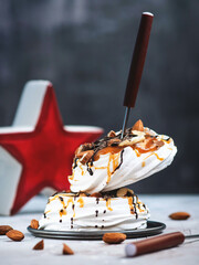 Meringue with chocolate, caramel filling and nuts. Sweet dessert. 