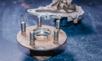 Fototapeta na wymiar concept of replacing the old rusty hub and wheel bearing, car dismantling.