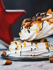 Meringue with chocolate, caramel filling and nuts. Sweet dessert. 