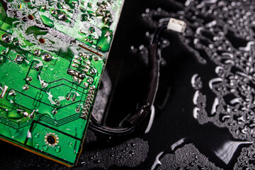 Wet circuit board with electrical paths. Water drops on an electronic device.