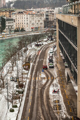 GENEVA, SWITZERLAND - February 13, 2021: Road along Rhone after snow blizzard near the former hydro power plant building in Geneva.