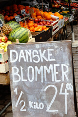 Sign with price offer for Danish plums at the market stalls.