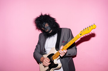 Man with gorilla mask playing electric guitar