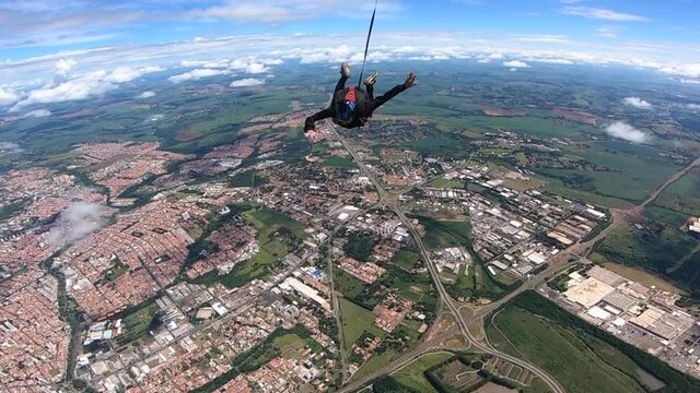 Parachutist opens his parachute. Slow motion video.