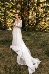 Fototapeta na wymiar Bride in white dress in nature