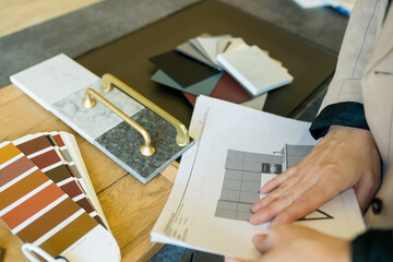 Designer woman choosing details of new kitchen in a home improvement store. Real estate, home renovation, small business concept