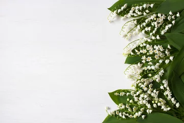 Foto auf Acrylglas Lily of the valley flowers on white wooden background and space for text © tachinskamarina