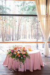 banquet table is decorated with plates, cutlery, glasses, candles and flower arrangements