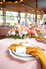 banquet table is decorated with plates, cutlery, glasses, candles and flower arrangements