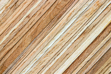Close-up of a stack of oak strips. The diagonally layered textured surface can serve as a background image.