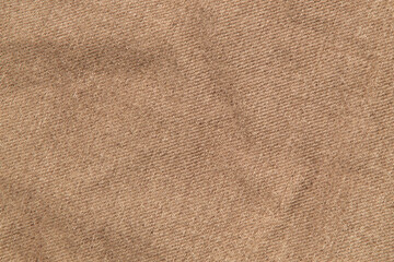 fabric grunge background, real cotton denim brown, wrinkled, frayed, close