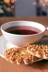 A cup of tea with cookies.