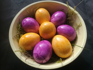 Easter decoration with colored eggs against a black background