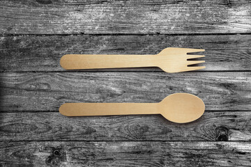 Wooden spoon and fork isolated on wooden background