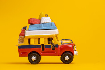 Right side of toy car vehicle with the colors of Colombia. Studio still life toy against a seamless yellow background