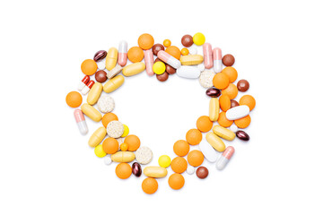 drugs and pills isolated on white background. heart shape made by tablets. cardiac medication concept