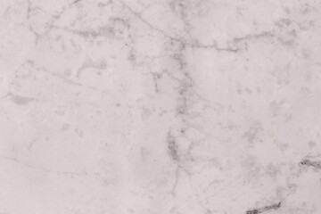 An abstract shot of a white tile with a grey marbled design.
