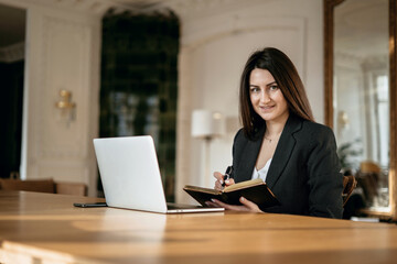 a financier is a business woman working on a computer. opens the laptop and prints the password. the lawyer in the company for Finance in the Bank. Modern office