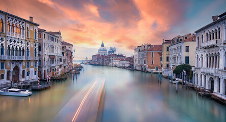 Stunning view of the Venice skyline with the Canal Grande and the Basilica Santa Maria Della Salute in the distance during a beautiful sunrise. Venice, Italy.