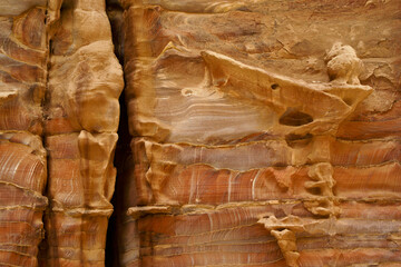 Beautiful patterns and fissures in the variegated red rock at Petra, Jordan