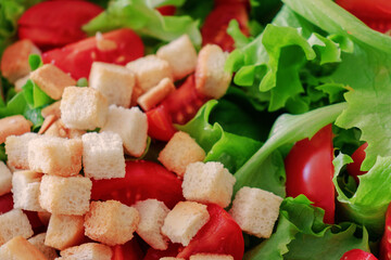 close-up of a fresh salad, tomatoes, and bread. Top view. Copy space