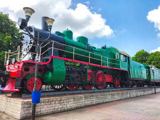 vintage green train locomotive at the station