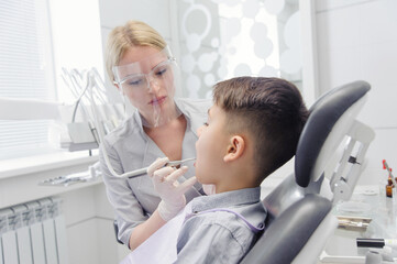 Fototapeta premium A child boy with a dentist in a dental office
