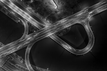 graphic drone top down shot of complex road system with interchange, traffic, bridge, ramps and...