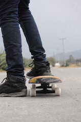 young man practicing sport with a skateboard in the street