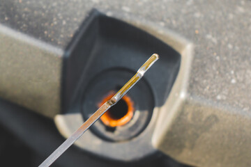 Car oil measurement by dipstick. Fresh oil. Maximum oil level. Selective focus