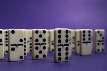 Old fashioned dirty domino stands on a solid backround
