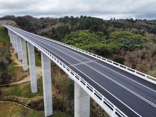 new road over a concrete bridge over beautiful scenery