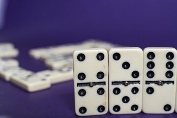 Old fashioned dirty domino stands on a solid backround
