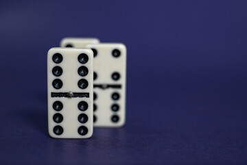 Old fashioned dirty domino stands on a solid backround
