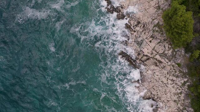 Aerial view of agitated Adriatic sea water hitting the coast of Ciovo island, Croatia.