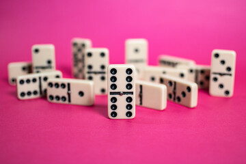 Old fashioned dirty domino on a box with pink solid backround
