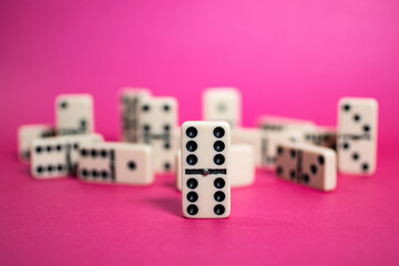 Old fashioned dirty domino on a box with pink solid backround
