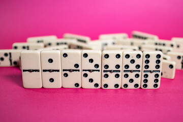 Old fashioned dirty domino on a box with pink solid backround
