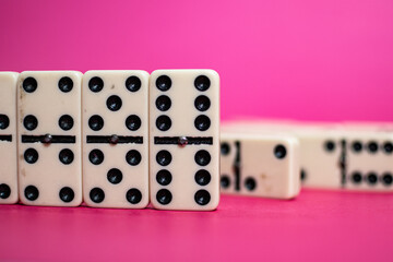 Old fashioned dirty domino on a box with pink solid backround
