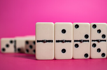 Old fashioned dirty domino stands on a solid backround
