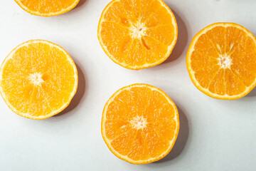 Slices of orange or tangerine isolated on white background. Flat lay, top view. Fruit composition