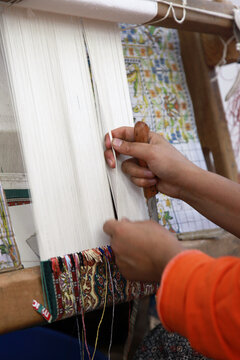 A woman making Traditional Turkish Carpet at Cappadocia in Nevsehir, Turkey.